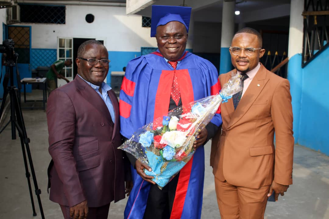 A graduate of ICOF Global University in academic dress, congratulated after the congregation